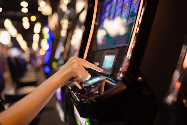 A young woman relaxing with her phone while dynamic casino elements float around her, illustrating the smooth mobile experience offered by the DECO X50 app.