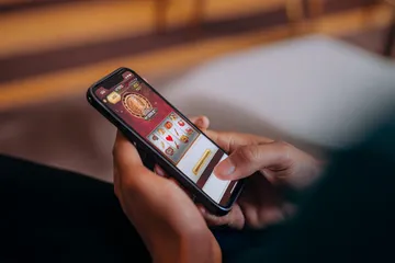 A cheerful woman in traditional clothing using her smartphone during a festive moment, showing how easily the DECO X50 app fits into everyday life.