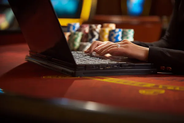 A glowing roulette wheel with cascading chips, symbolizing the engaging live and instant-win games available on DECO X50.